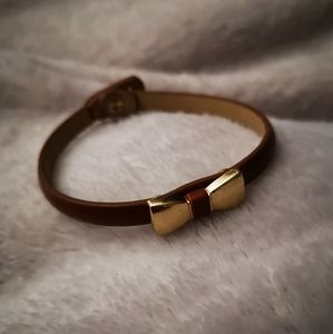 Leather bracelet with gold tone bow tie